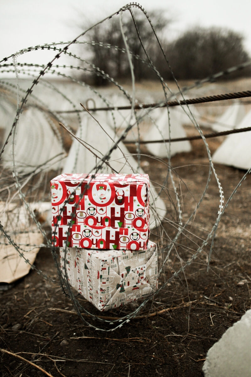Christmas gifts for children beside defensive barriers.
Dnipropetrovsk region, Ukraine. Winter 2024.